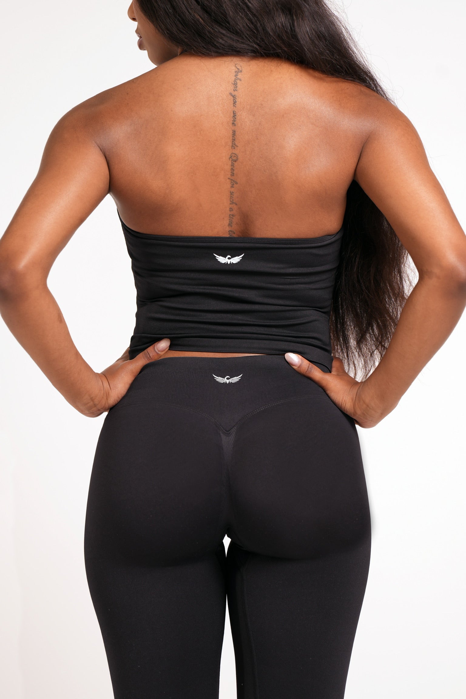Woman wearing black leggings on a white background