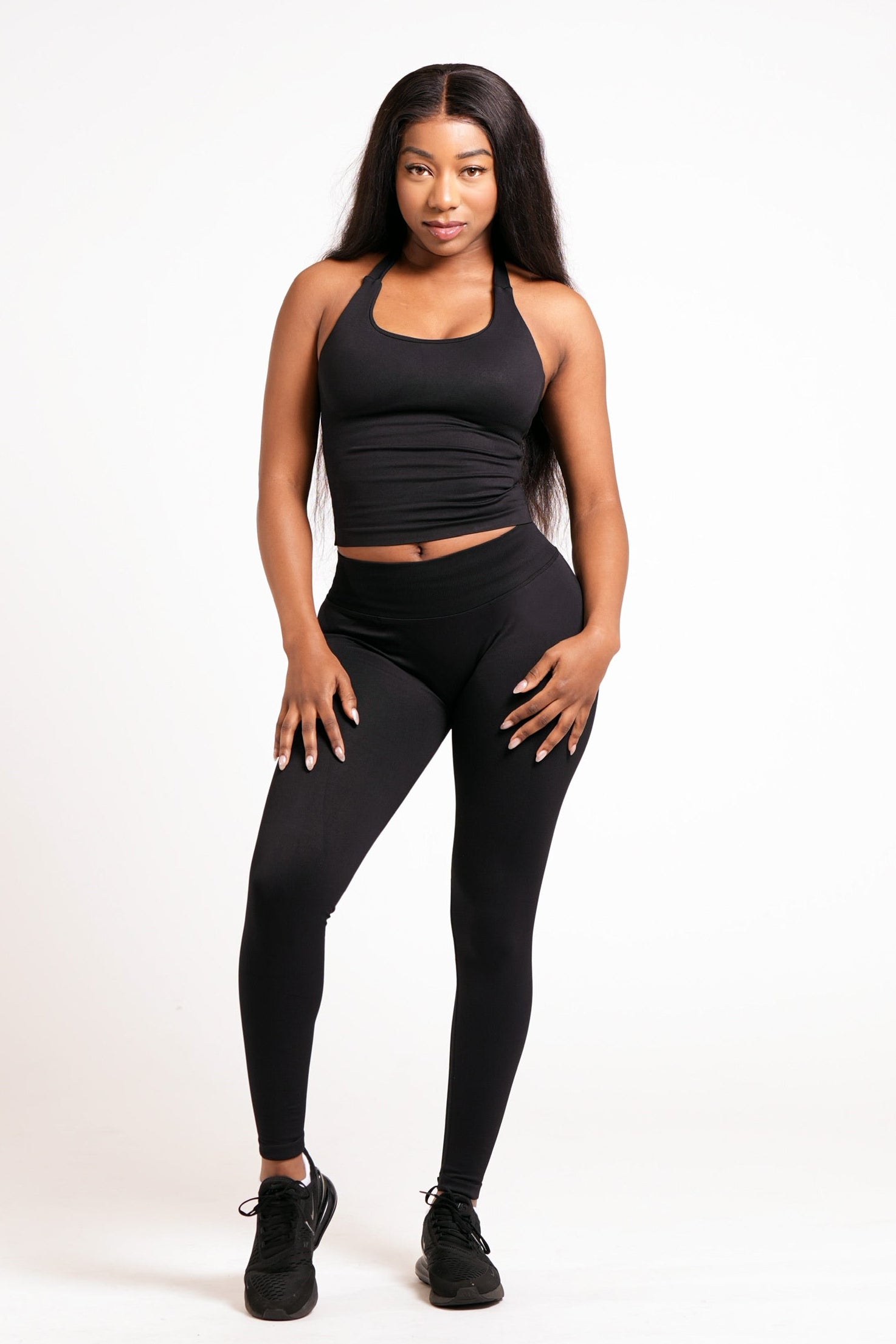 Woman wearing black leggings on a white background