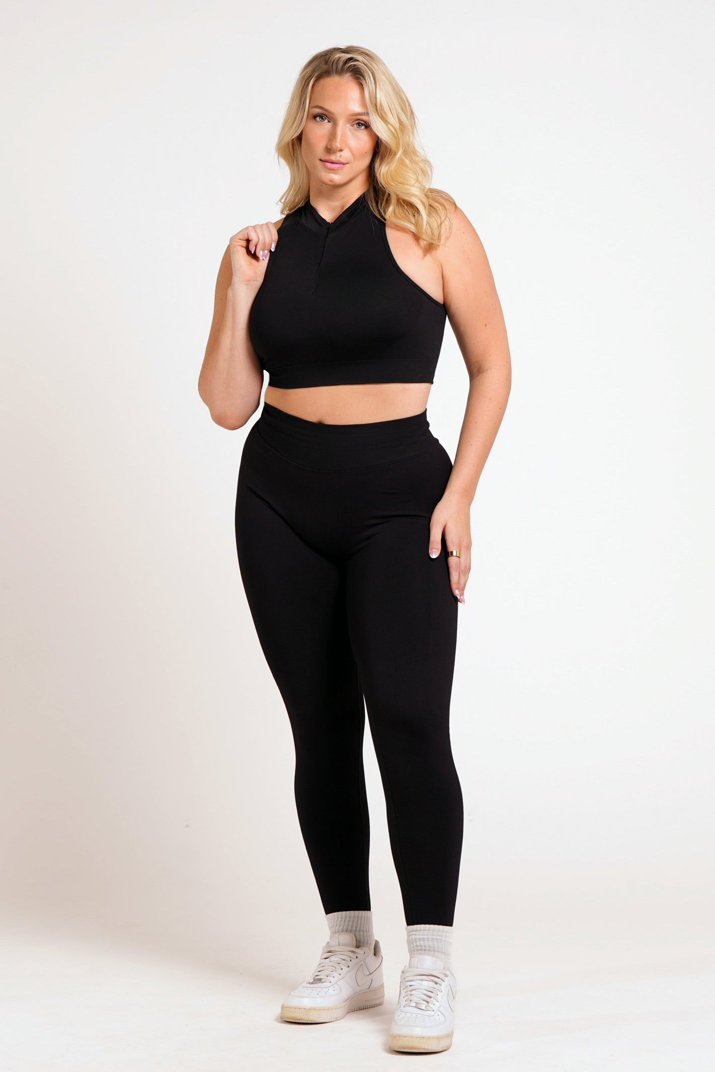Woman wearing black leggings on a white background